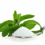 Fresh Stevia Rebaudiana and sugar in a spoon